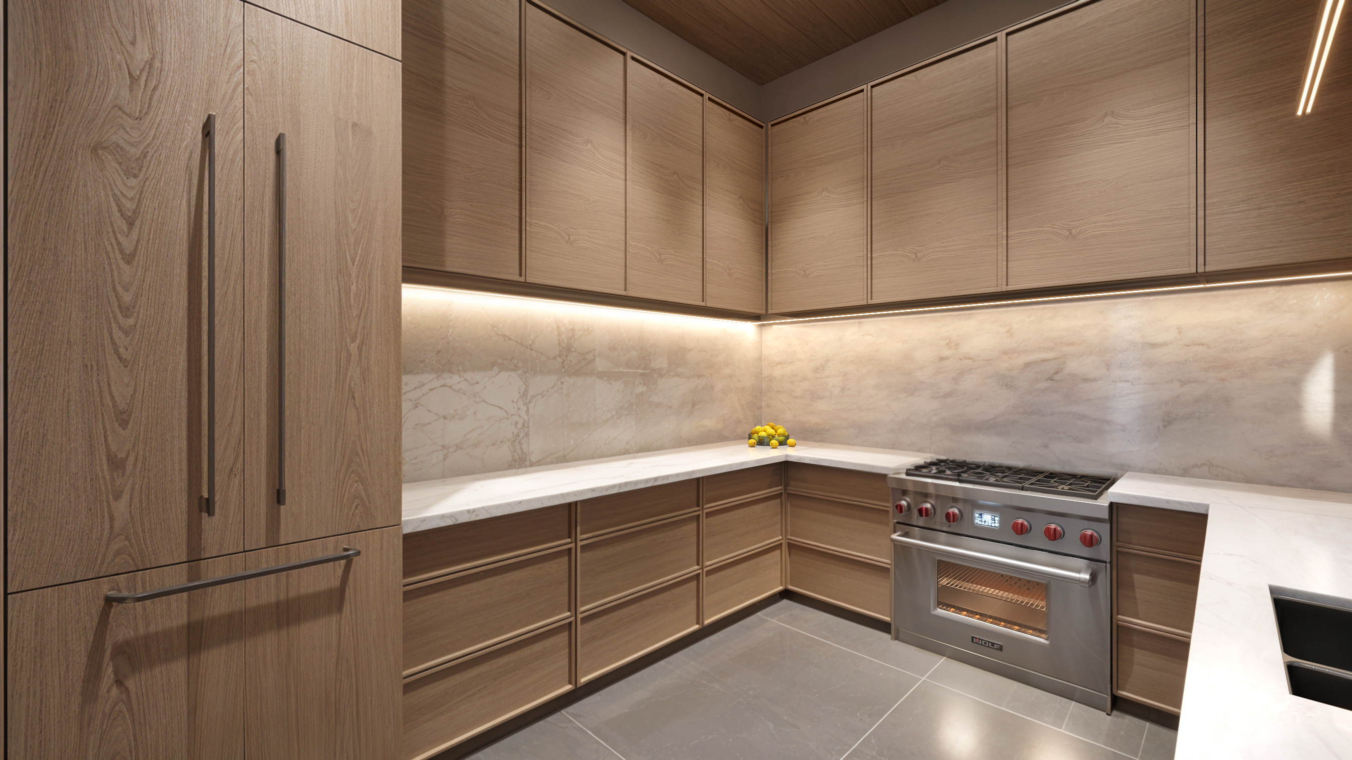 Butler's kitchen from the entry — full-height paneled refrigeration, Wolf range and marble counters wrapping the corner