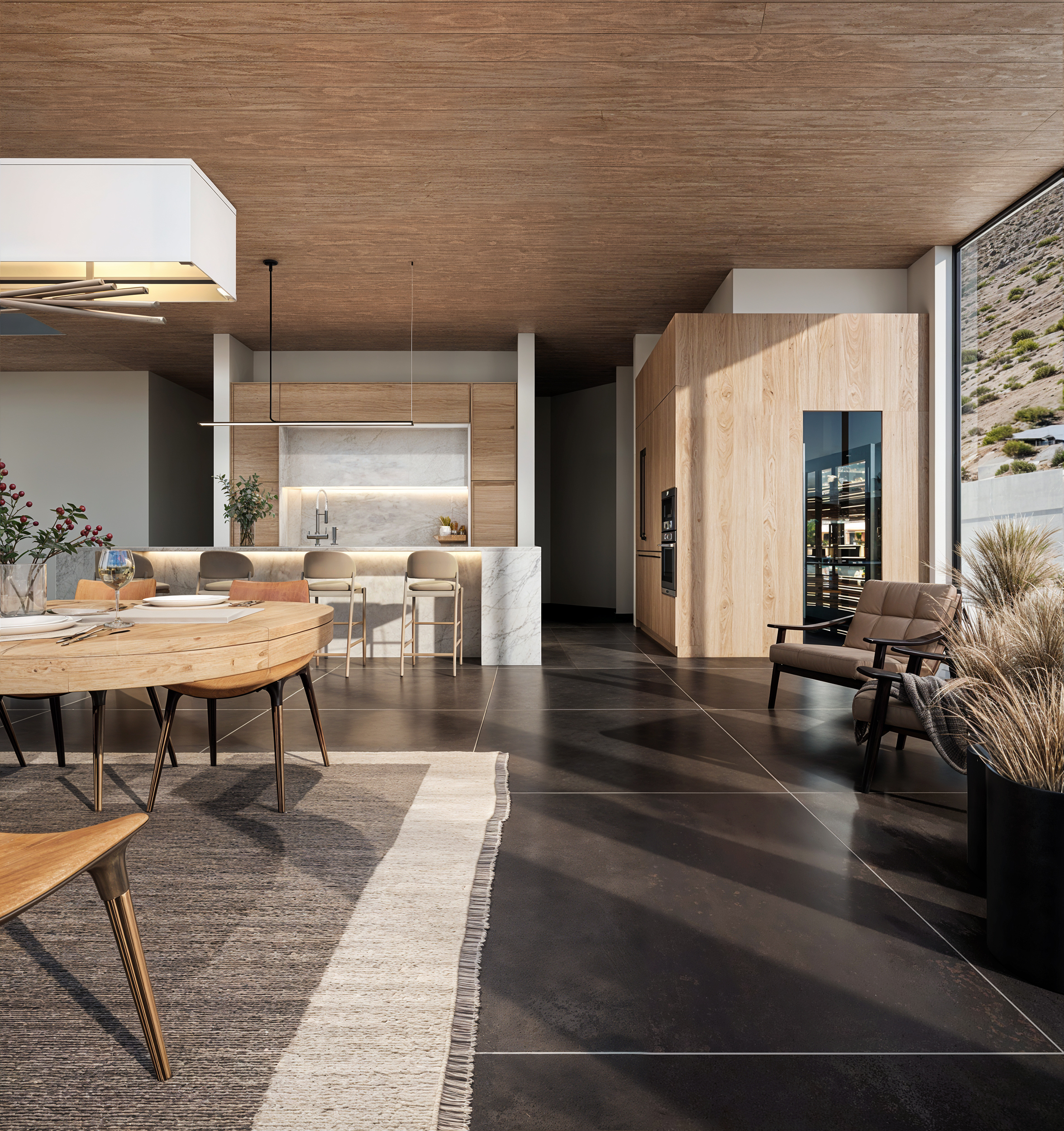 Dining table and kitchen island with marble waterfall and hillside view