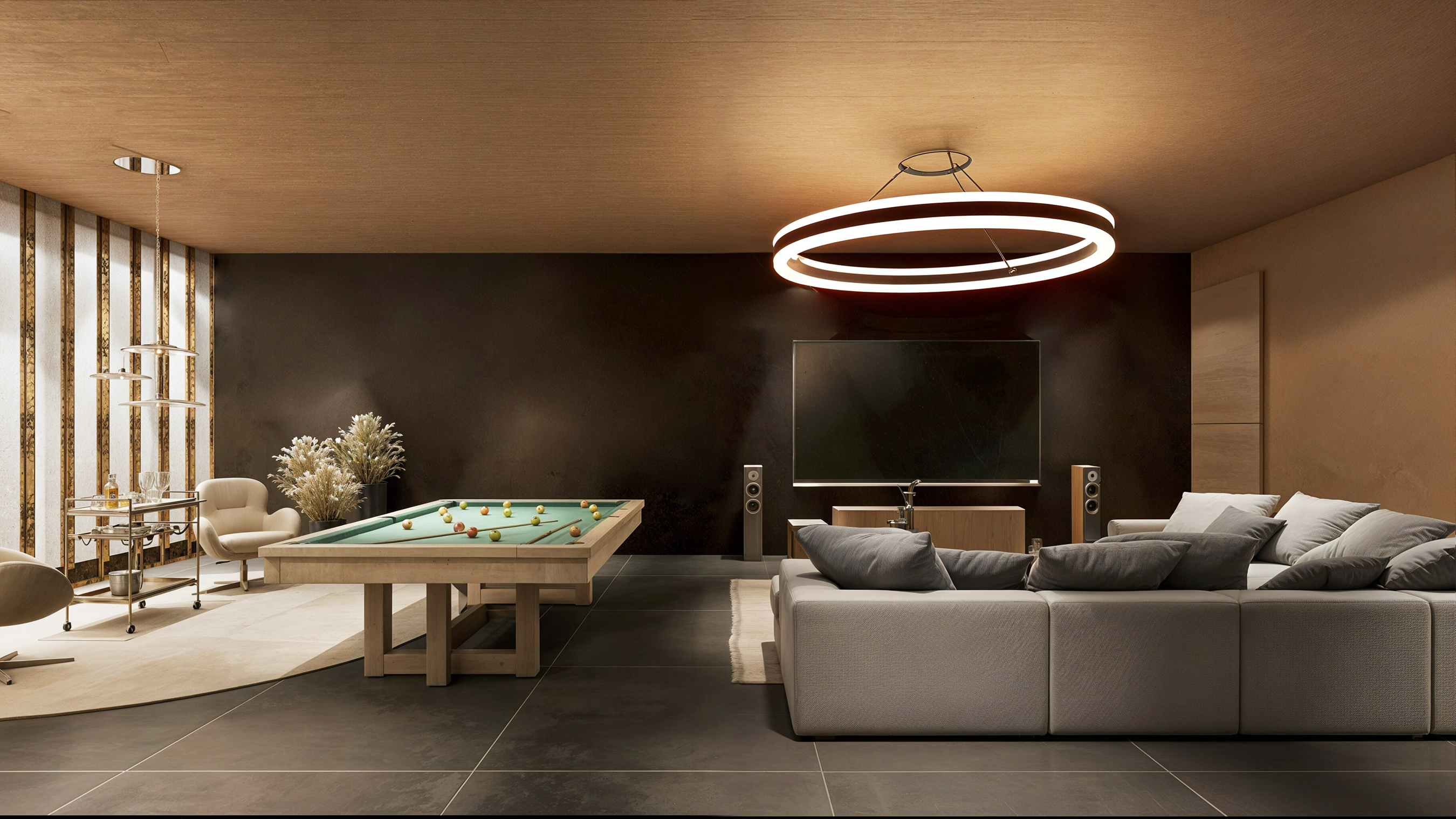 The lounge from the living end — modular grey sectional, large flat screen and pool table off to the side